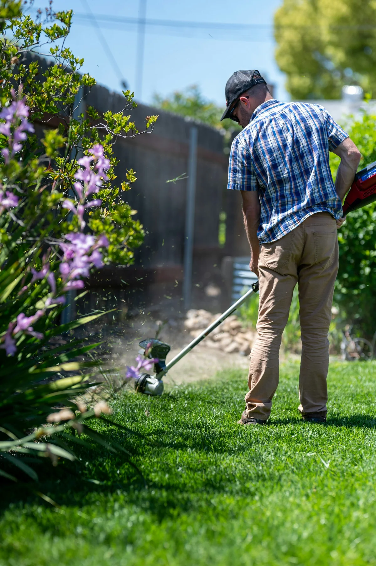 A landscaper maintaining the edge of a garden